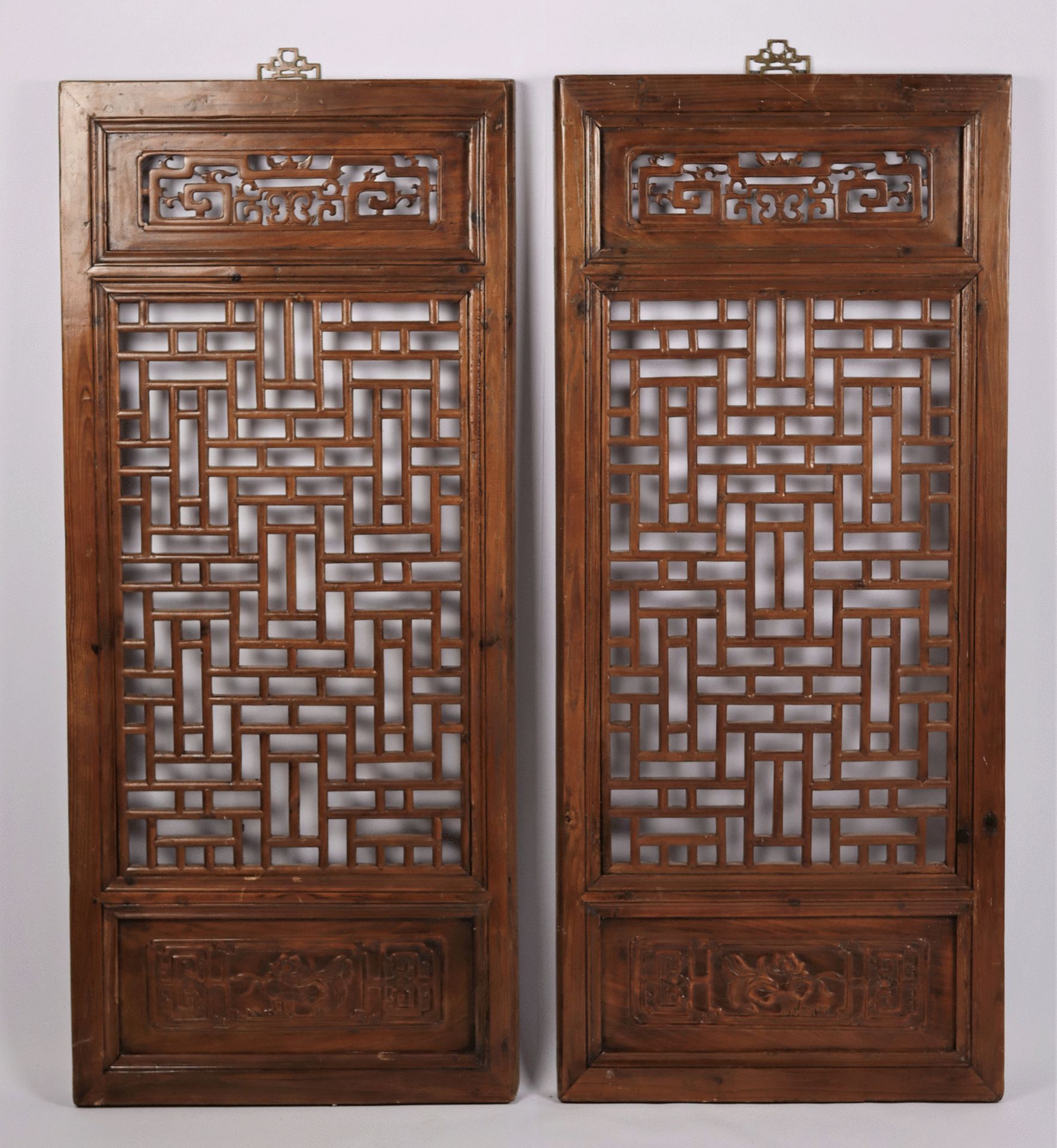 A pair of Chinese fretwork screens with carved motifs. Qing Dynasty, 19th Century