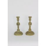 A pair of French Neoclassical bronze candlesticks, 18th Century