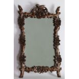 A Chinese mirror shaped with carved flowers and branches, first half 20th Century