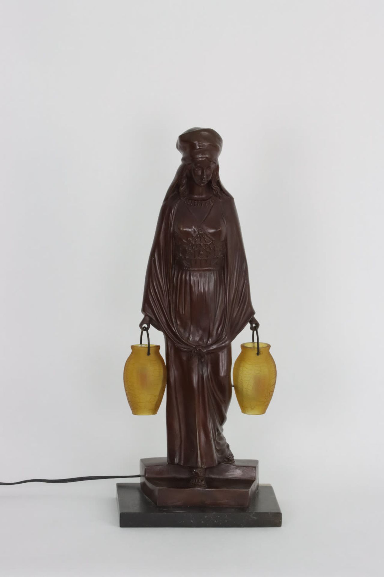 A figural lamp of a lady holding two lanterns, 20th Century