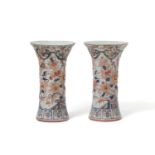 A pair of relief Imari style beaker vases, 19th Century