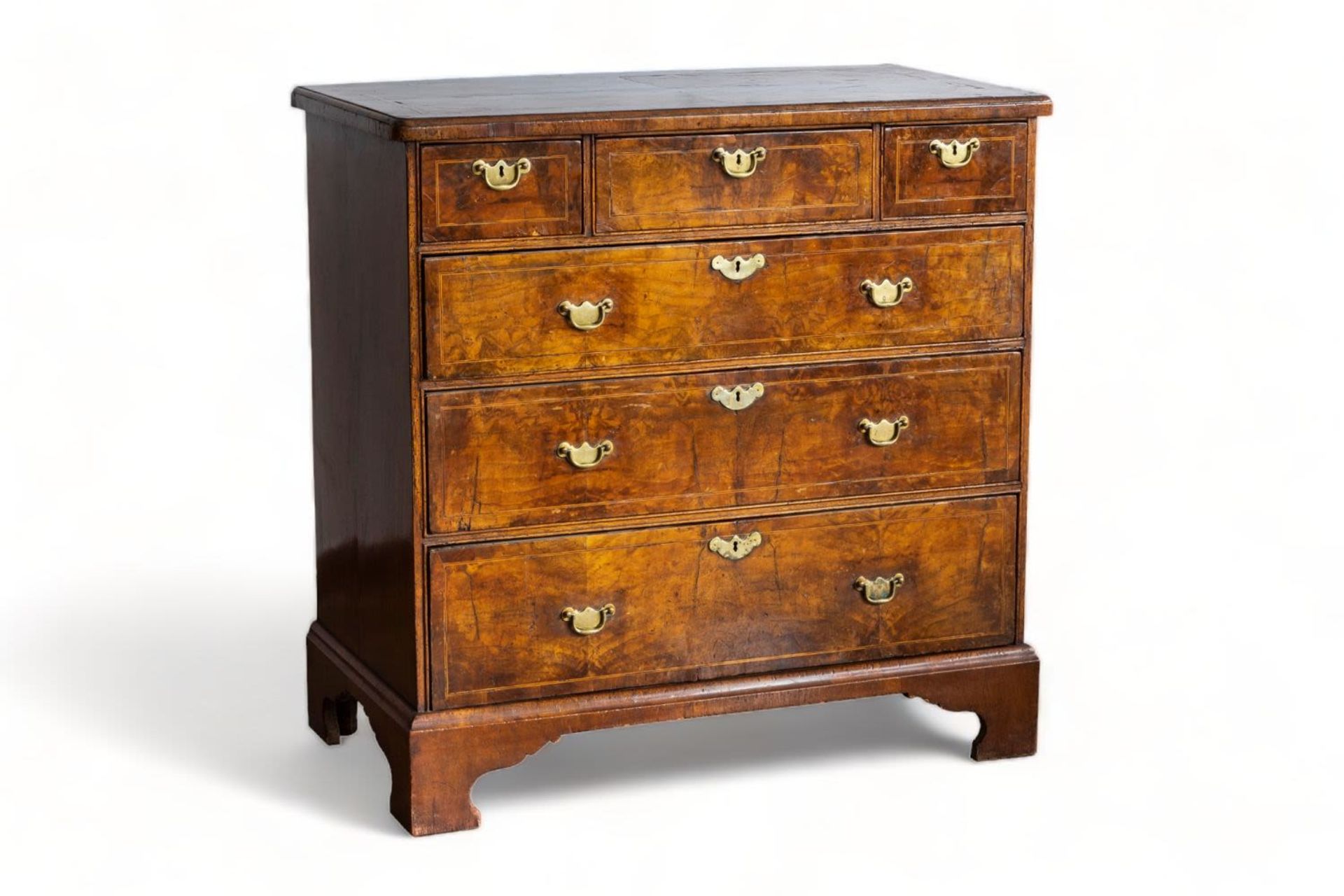 An English George I walnut chest with three short and three long graduated drawers, first half 18th 