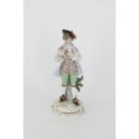 A porcelain statue of a gentleman holding a dove, first quarter 20th Century