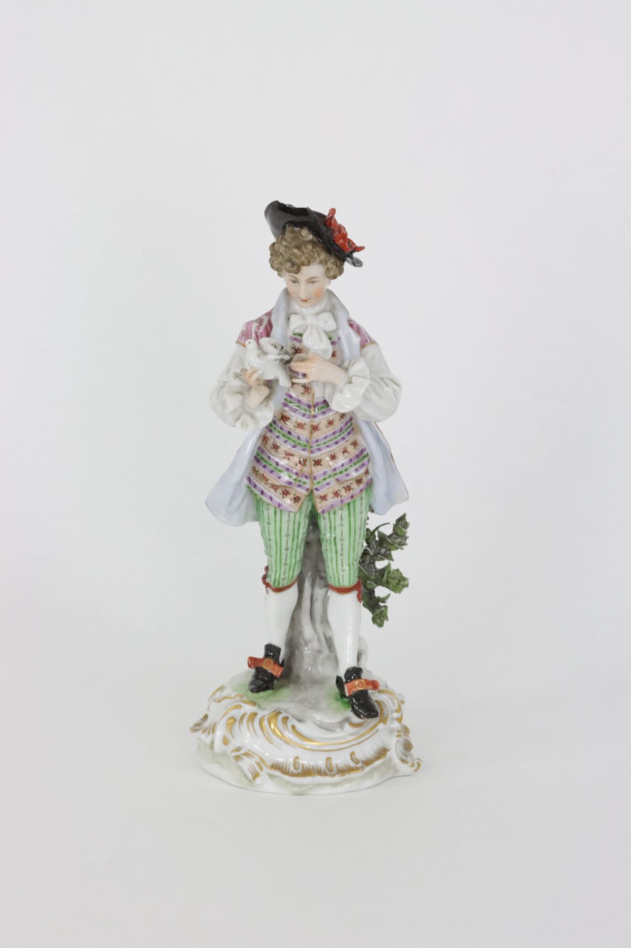 A porcelain statue of a gentleman holding a dove, first quarter 20th Century
