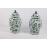 A pair of Chinese blue and white temple vases with antiquities and relief design, 19/20th Century