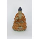 An earthenware glazed statue of Buddha, signed Wanjiang. 20th Century