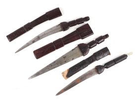 Three African daggers with leather hilts and scabbards. Having decorated blades. Longest blade