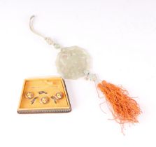 A Chinese pierced jade pendant decorated with a parrot amongst foliage; together with a boxed set of