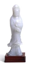 A Chinese jade figure depicting Guanyin, 13cms high.