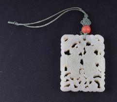 A Chinese pierced jade pendant, 5 by 6.5cms.