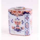 A Delft three-colour octagonal tea caddy decorated with flowers, 10cms high.