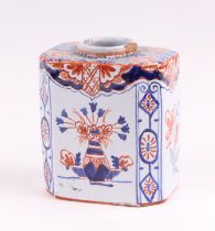 A Delft three-colour octagonal tea caddy decorated with flowers, 10cms high.