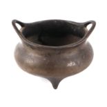 A Chinese bronze tripod censer with loop handles, cast six-character mark to the base, 12.5cms