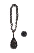 A Victorian Vulcanite necklace and pendant; together with a carved jet brooch (3).