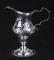 A George III silver cream jug, London 1786 and maker's mark for Charles Hougham, 11cms high, 75g.