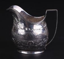 A George III silver cream jug ornately decorated with flowers and shells, London 1804, 9.5cms