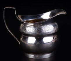 A George III silver milk jug with foliate scrolls and Greek key decoration, London 1805 and maker'