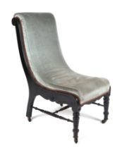 A Victorian ebonised slipper chair with upholstered seat.