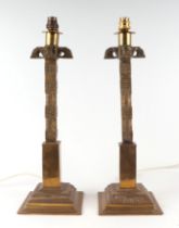 A pair of early 20th century Anglo-Persian cast brass table lamps with square section columns, on