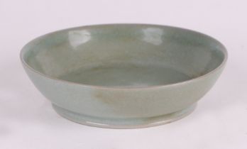 A Chinese celadon ground shallow footed bowl, 14cms diameter.