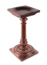 A carved mahogany candle stand with vase shaped reeded column, 18cms wide.