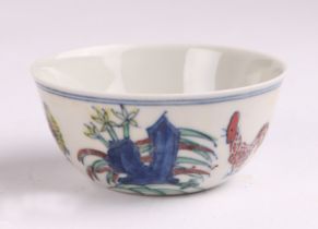 A Chinese Wucai style tea bowl decorated with chickens and flowers, six character blue mark to the