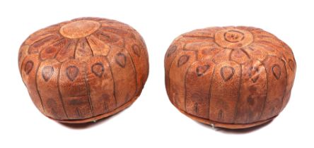 A pair of Moroccan tooled leather pouffes, approx 50cms diameter (2).