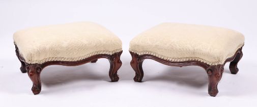 A pair of Victorian style mahogany footstools on dwarf cabriole legs, each 35cms wide (2).