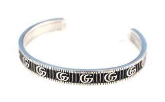 A Gucci silver bangle, 6.5cm wide, boxed weight 26.3g