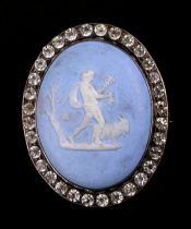 A Wedgwood Jasperware oval brooch within a paste set border, 1.5 by 5.5cms.