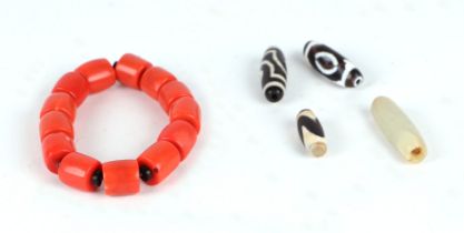 A group of Tibetan Dzi type beads; together with a coral type bracelet.