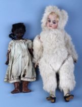 A 19th century Eskimo 'Snow Baby' doll with bisque head and open blue eyes, 40cms high (legs