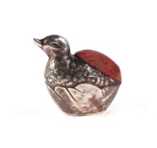 An Edwardian novelty silver pin cushion in the form of a chick emerging from an egg, Birmingham 1908
