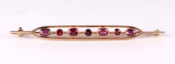 A 15ct gold and ruby bar brooch, 7cms wide, 6.1g.