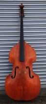 A double bass with single piece back, ebony finger board and heavily carved scroll with brass plates