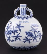 A Chinese blue & white two-handled moon flask decorated with flowering foliage, 26cms high.