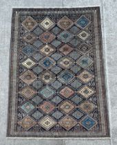 A large Persian rug decorated a geometric design. 203 by 295cm