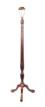 A mahogany standard lamp with reeded column on tripod base.