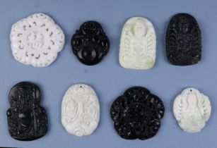 A group of Chinese carved hardstone pendants, the largest 5cms high (8).