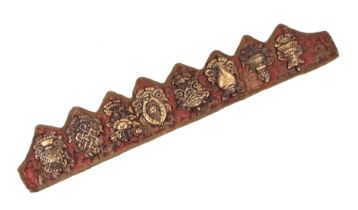 A group of Tibetan bronze / brass plaques mounted on textile, each approx 9 by 6cms.