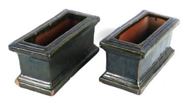 A pair of green glazed terracotta planters, each 34cm wide, (2)
