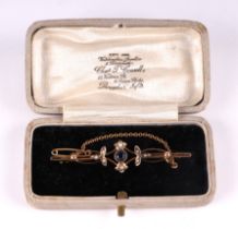 A late Victorian / Edwardian 9ct gold seed pearl and blue stone bar brooch, 2.7g.
