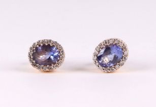 A pair of 18ct gold tanzanite and diamond stud earrings, 4.3g. Condition Report Both tanzanites have