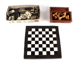 A boxwood chess set; together with an ebony and bone chess board and draughts pieces. Condition