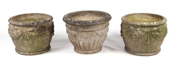 A pair of well weathered reconstituted stone circular planters, 39cms diameter; together with