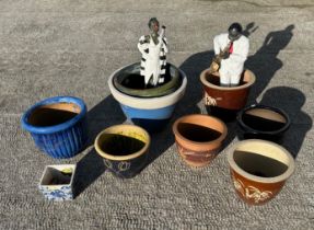 A collection of glazed plant pots, the largest 38cms diameter, together with two plastic Jazz