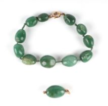 A jade / hardstone bead bracelet; together with a matching yellow metal mounted pendant.