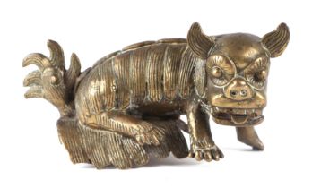 A cast brass figure of a dog of fo, 14cms wide.