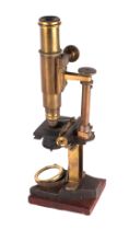 A Victorian monocular brass microscope with accessories, boxed.