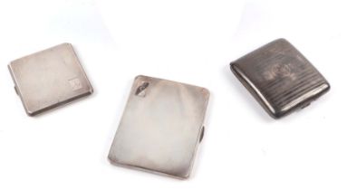 A silver cigarette case with engine turned decoration, Chester 1953; together with two other